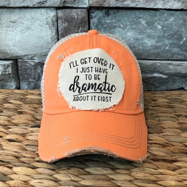 I’ll Get Over It I Just Have to Be Dramatic First hat by BohoGroove with black lettering on a distressed off-white patch on a sherbet vintage distressed snapback.