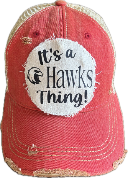 It's a Hawks Thing hat by BohoGroove featuring black lettering and a hawk graphic on a round cream frayed patch on a red vintage distressed snapback trucker hat.