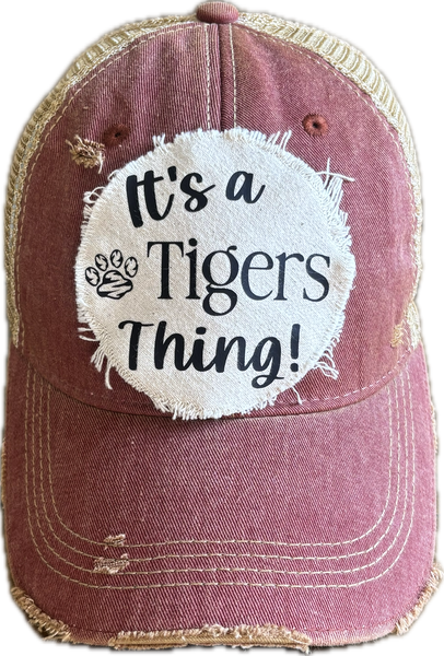 t's a Tigers Thing hat by BohoGroove featuring black lettering and a tiger paw graphic on a round cream frayed patch on a brick red vintage distressed snapback trucker hat.
