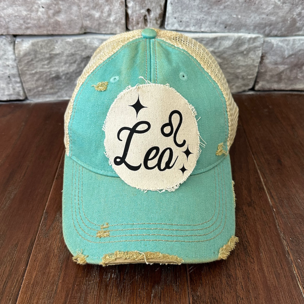 Leo hat by BohoGroove with black Leo lettering and constellation graphic on a distressed off-white custom patch on an ocean blue vintage distressed snapback.