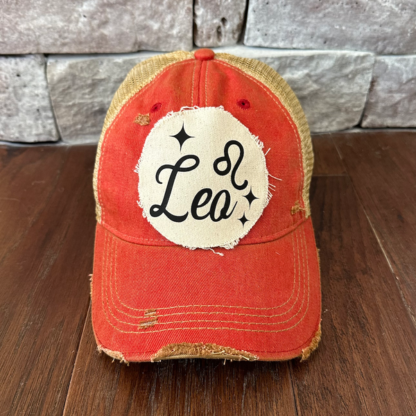 Leo hat by BohoGroove with black Leo lettering and constellation graphic on a distressed off-white custom patch on a red vintage distressed snapback.