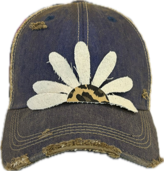 Leopard Daisy hat by BohoGroove featuring white daisy petals with a leopard print center on a royal blue vintage distressed snapback trucker hat.