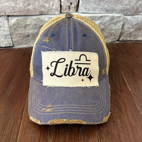 Libra hat by BohoGroove with black Libra lettering and constellation graphic on a distressed off-white custom patch on a royal blue vintage distressed snapback.