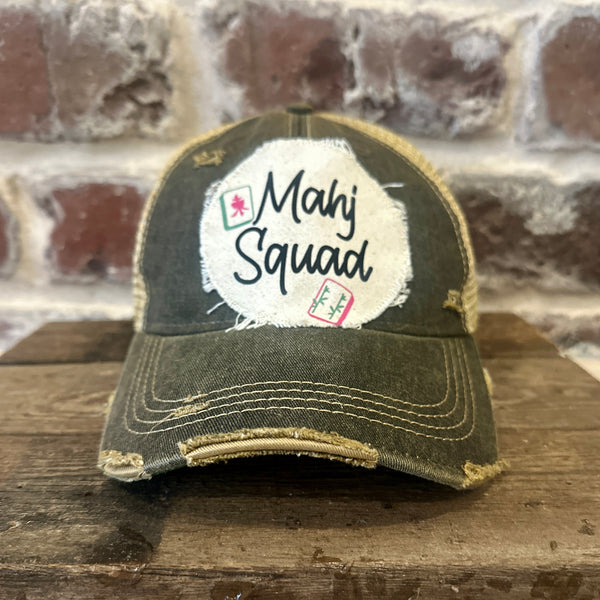 Mahj Squad hat by BohoGroove featuring black Mahj Squad lettering with Mahjong tile graphics on an off-white distressed patch on a black vintage distressed snapback trucker hat.