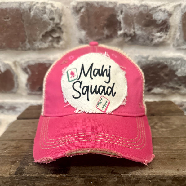 Mahj Squad hat by BohoGroove featuring black Mahj Squad lettering with Mahjong tile graphics on an off-white distressed patch on a pink vintage distressed snapback trucker hat.