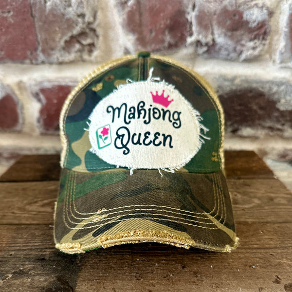 Mahjong Queen hat by BohoGroove featuring black Mahjong Queen lettering with a pink crown and Mahjong tile graphic on an off-white distressed patch on a camo vintage distressed snapback trucker hat.