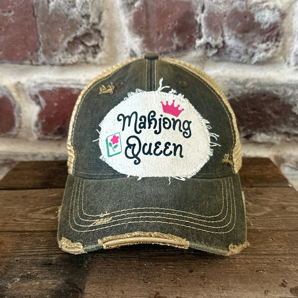 Mahjong Queen hat by BohoGroove featuring black Mahjong Queen lettering with a pink crown and Mahjong tile graphic on an off-white distressed patch on a black vintage distressed snapback trucker hat.