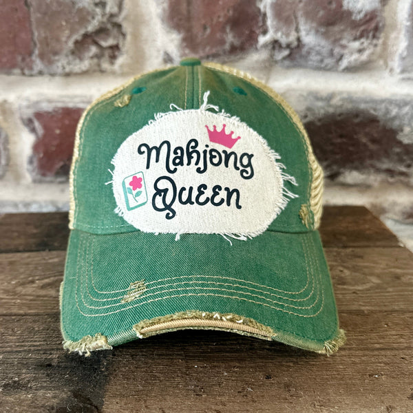 Mahjong Queen hat by BohoGroove featuring black Mahjong Queen lettering with a pink crown and Mahjong tile graphic on an off-white distressed patch on a green vintage distressed snapback trucker hat.