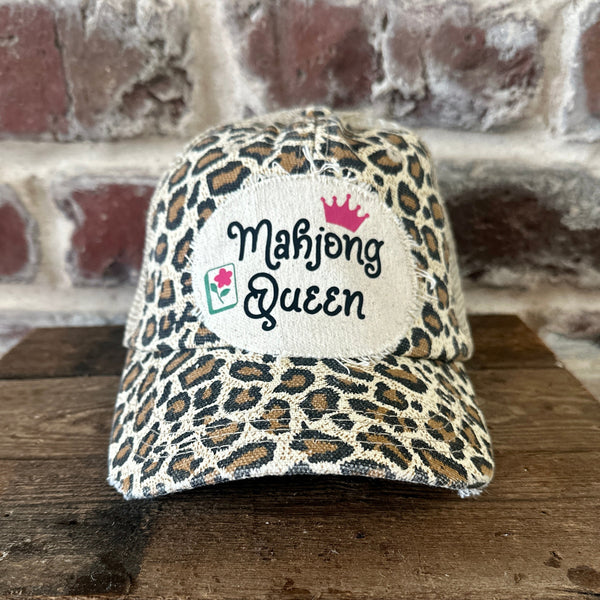 Mahjong Queen hat by BohoGroove featuring black Mahjong Queen lettering with a pink crown and Mahjong tile graphic on an off-white distressed patch on a leopard vintage distressed snapback trucker hat.