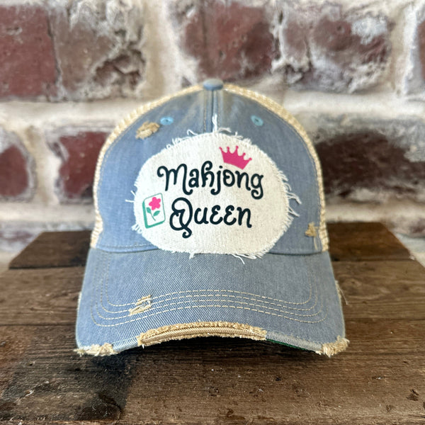 Mahjong Queen hat by BohoGroove featuring black Mahjong Queen lettering with a pink crown and Mahjong tile graphic on an off-white distressed patch on a light blue vintage distressed snapback trucker hat.