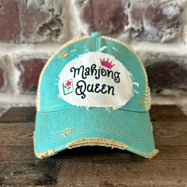 Mahjong Queen hat by BohoGroove featuring black Mahjong Queen lettering with a pink crown and Mahjong tile graphic on an off-white distressed patch on an ocean blue vintage distressed snapback trucker hat.