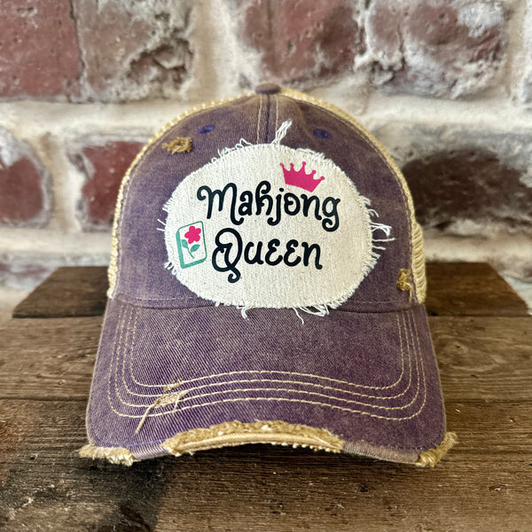 Mahjong Queen hat by BohoGroove featuring black Mahjong Queen lettering with a pink crown and Mahjong tile graphic on an off-white distressed patch on a purple vintage distressed snapback trucker hat.