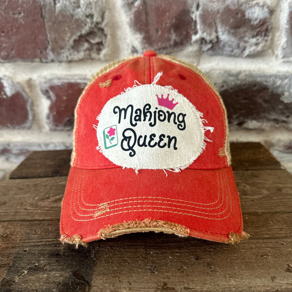 Mahjong Queen hat by BohoGroove featuring black Mahjong Queen lettering with a pink crown and Mahjong tile graphic on an off-white distressed patch on a red vintage distressed snapback trucker hat.