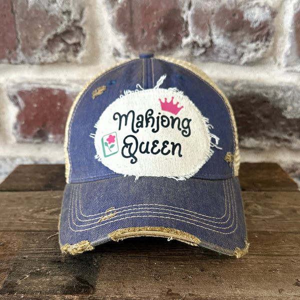 Mahjong Queen hat by BohoGroove featuring black Mahjong Queen lettering with a pink crown and Mahjong tile graphic on an off-white distressed patch on a royal vintage distressed snapback trucker hat.