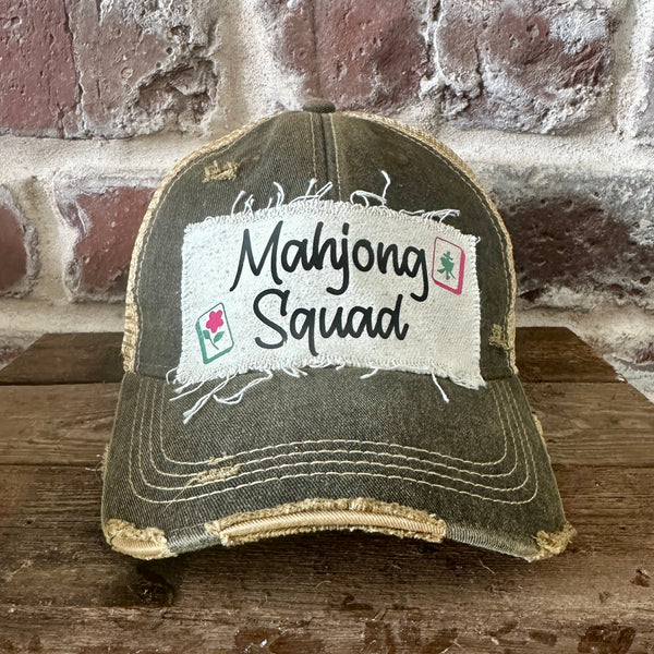 Mahjong Squad hat by BohoGroove featuring black Mahjong Squad lettering with Mahjong tile graphics on an off-white distressed patch on a black vintage distressed snapback trucker hat.