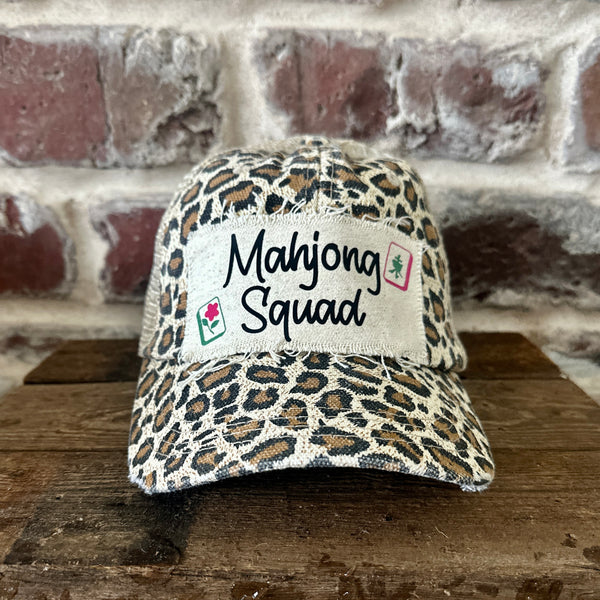 Mahjong Squad hat by BohoGroove featuring black Mahjong Squad lettering with Mahjong tile graphics on an off-white distressed patch on a leopard vintage distressed snapback trucker hat.