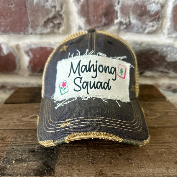 Mahjong Squad hat by BohoGroove featuring black Mahjong Squad lettering with Mahjong tile graphics on an off-white distressed patch on a navy vintage distressed snapback trucker hat.