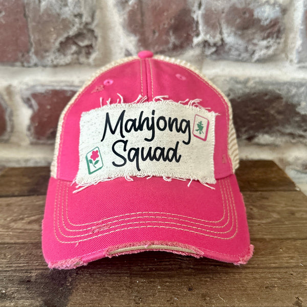Mahjong Squad hat by BohoGroove featuring black Mahjong Squad lettering with Mahjong tile graphics on an off-white distressed patch on a pink vintage distressed snapback trucker hat.