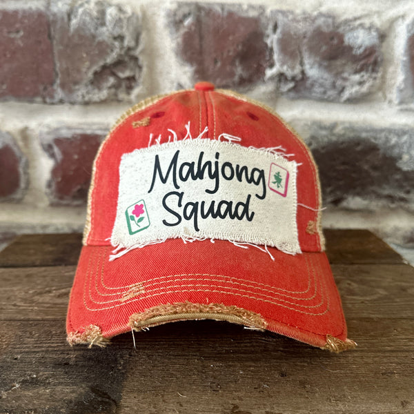 Mahjong Squad hat by BohoGroove featuring black Mahjong Squad lettering with Mahjong tile graphics on an off-white distressed patch on a red vintage distressed snapback trucker hat.
