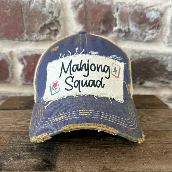 Mahjong Squad hat by BohoGroove featuring black Mahjong Squad lettering with Mahjong tile graphics on an off-white distressed patch on a royal vintage distressed snapback trucker hat.