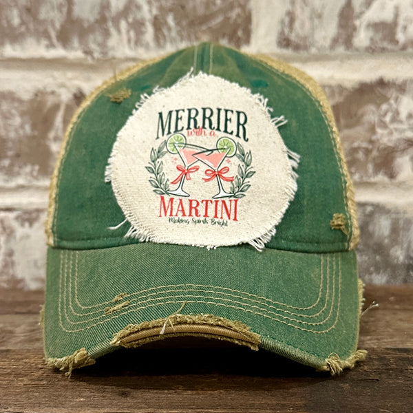Merrier With a Martini hat by BohoGroove featuring a holiday martini design on a Green vintage distressed snapback trucker hat.
