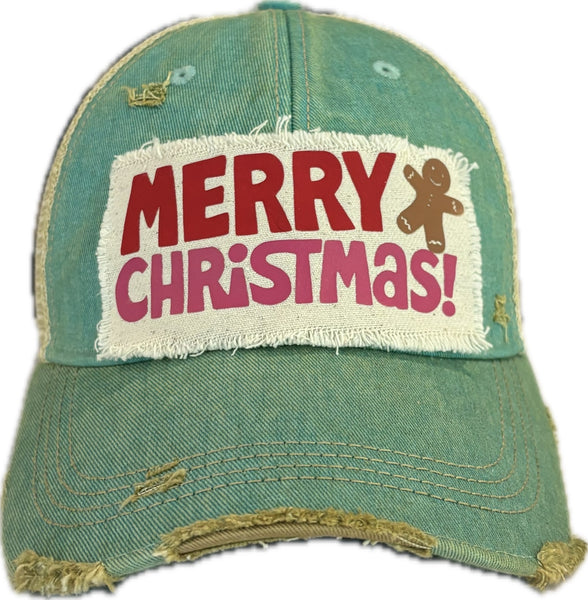 Merry Christmas Gingerbread hat by BohoGroove with red and pink Merry Christmas lettering and a gingerbread man graphic on a distressed off-white custom patch on an ocean blue vintage distressed snapback.