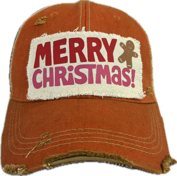Merry Christmas Gingerbread hat by BohoGroove with red and pink Merry Christmas lettering and a gingerbread man graphic on a distressed off-white custom patch on an orange vintage distressed snapback.