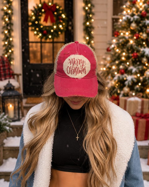 Merry Christmas Glitter hat by BohoGroove with red glitter Merry Christmas script lettering on a distressed off-white custom patch on a pink vintage distressed snapback on model.