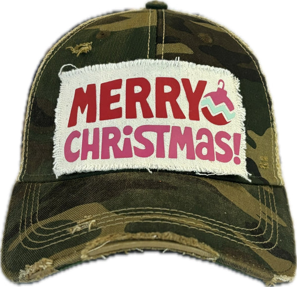 Merry Christmas Ornament hat by BohoGroove with red and pink Merry Christmas lettering and a pink ornament graphic on a distressed off-white custom patch on a camo vintage distressed snapback.