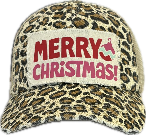 Merry Christmas Ornament hat by BohoGroove with red and pink Merry Christmas lettering and a pink ornament graphic on a distressed off-white custom patch on a leopard vintage distressed snapback.