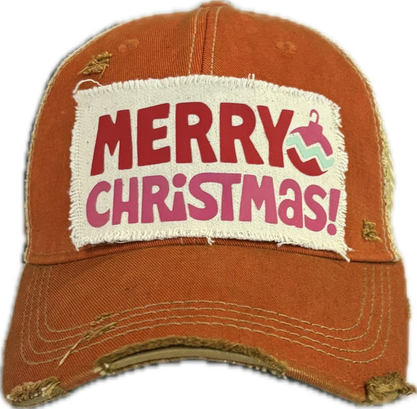Merry Christmas Ornament hat by BohoGroove with red and pink Merry Christmas lettering and a pink ornament graphic on a distressed off-white custom patch on an orange vintage distressed snapback.