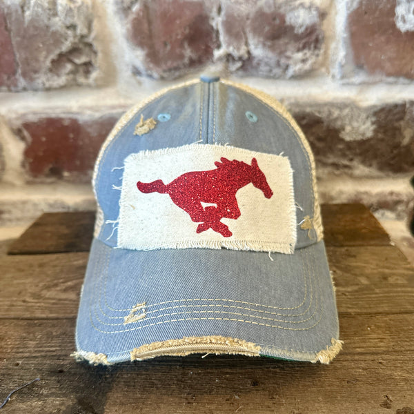 Mustang Pony Glitter Hat by BohoGroove with a red glitter running pony on a distressed off-white patch on a light blue vintage distressed snapback trucker hat.