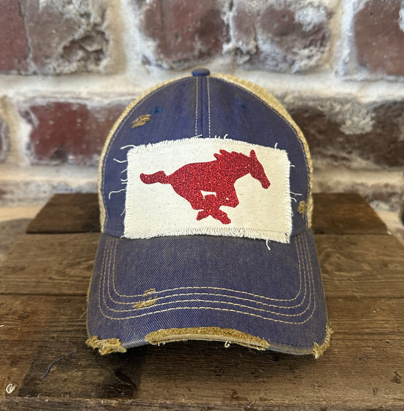Mustang Pony Glitter Hat by BohoGroove with a red glitter running pony on a distressed off-white patch on a royal blue vintage distressed snapback trucker hat.