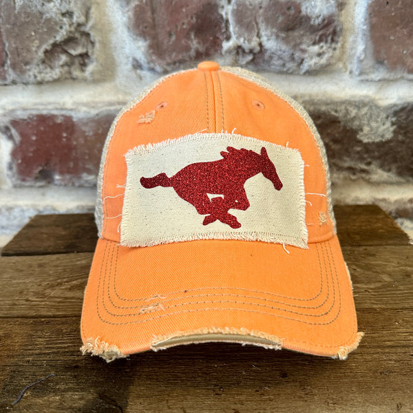 Mustang Pony Glitter Hat by BohoGroove with a red glitter running pony on a distressed off-white patch on a sherbet vintage distressed snapback trucker hat.
