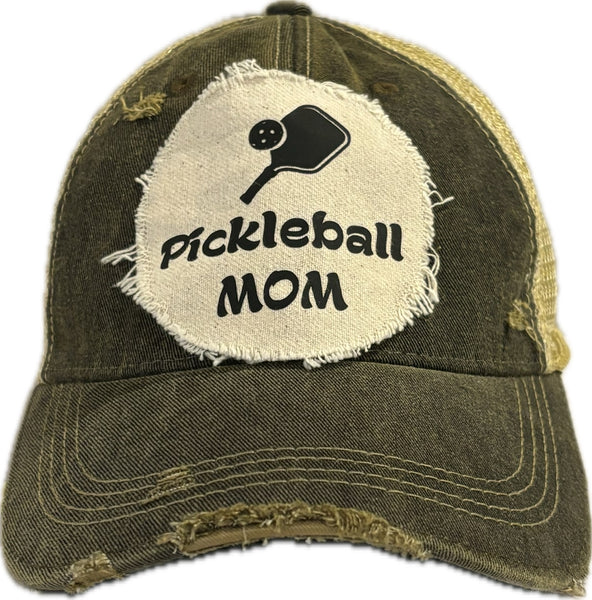 Pickleball Mom hat by BohoGroove featuring black Pickleball Mom lettering and black pickleball paddle graphic on a black vintage distressed snapback hat