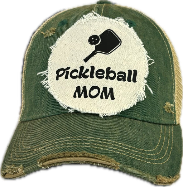 Pickleball Mom hat by BohoGroove featuring black Pickleball Mom lettering and black pickleball paddle graphic on a green vintage distressed snapback hat