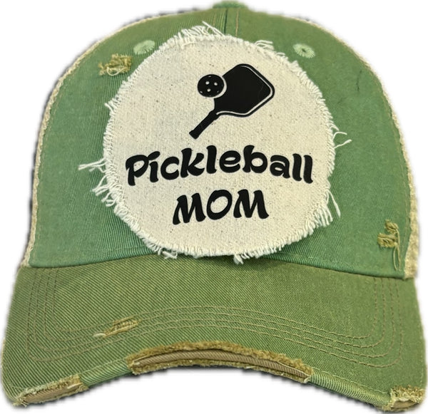 Pickleball Mom hat by BohoGroove featuring black Pickleball Mom lettering and black pickleball paddle graphic on a mint vintage distressed snapback hat