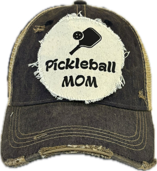 Pickleball Mom hat by BohoGroove featuring black Pickleball Mom lettering and black pickleball paddle graphic on a navy blue vintage distressed snapback hat