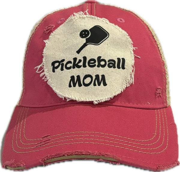 Pickleball Mom hat by BohoGroove featuring black Pickleball Mom lettering and black pickleball paddle graphic on a pink vintage distressed snapback hat