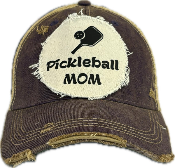 Pickleball Mom hat by BohoGroove featuring black Pickleball Mom lettering and black pickleball paddle graphic on a purple vintage distressed snapback hat