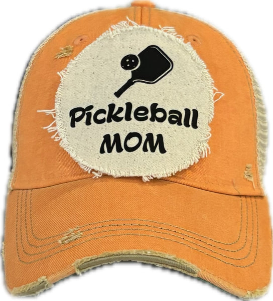 Pickleball Mom hat by BohoGroove featuring black Pickleball Mom lettering and black pickleball paddle graphic on a sherbet vintage distressed snapback hat