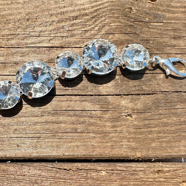 Rhinestone hat chain by BohoGroove, Big Time, featuring oversized clear rhinestones in graduated sizes on a silver tone chain close up view.