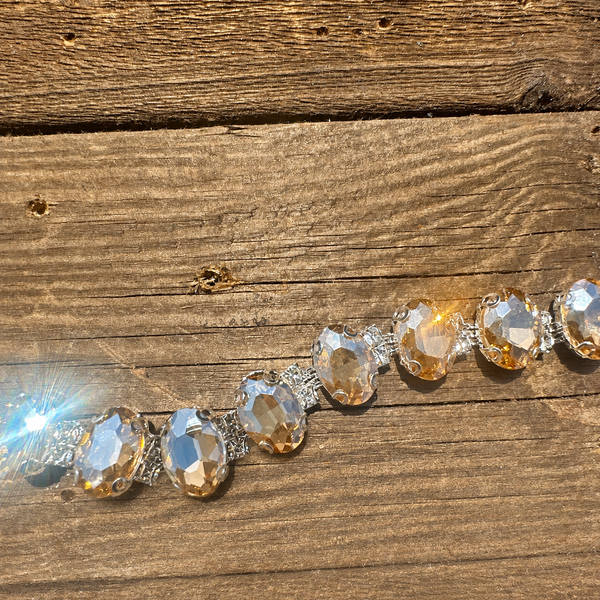 Rhinestone hat chain by BohoGroove, Champagne Wishes, showing faceted champagne rhinestones with sparkling clear rhinestone details on a silver tone chain.
