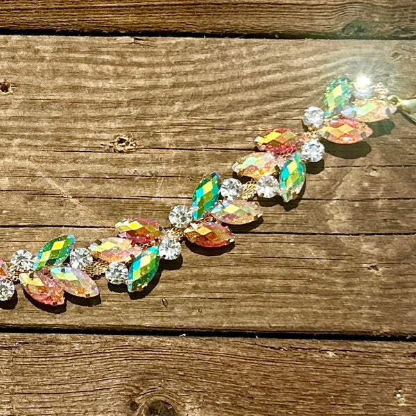 Rhinestone hat chain by BohoGroove, Electric Bloom, showing colorful iridescent leaf shaped rhinestones and clear rhinestone details on a gold tone chain.