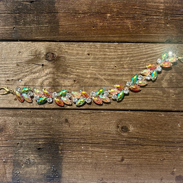 Rhinestone hat chain by BohoGroove, Electric Bloom, featuring colorful iridescent leaf shaped rhinestones with clear rhinestone accents on a gold tone chain with lobster clips.