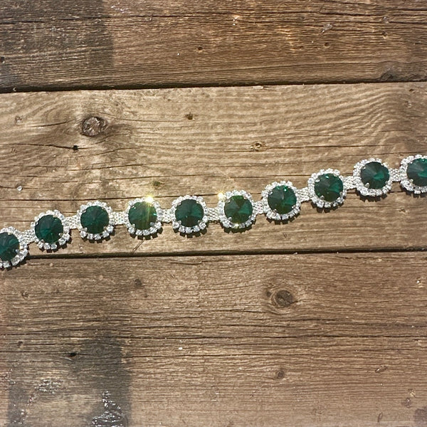 Rhinestone hat chain by BohoGroove, Emerald City, featuring oversized emerald green round rhinestones with clear rhinestone accents on a silver tone chain.
