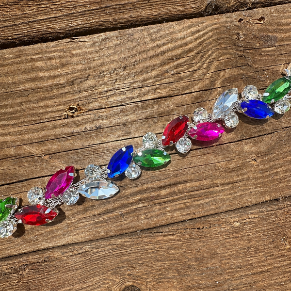 Rhinestone hat chain by BohoGroove, Over the Rainbow, showing blue, green, red and pink rhinestones with sparkling clear rhinestone details on a silver tone chain.