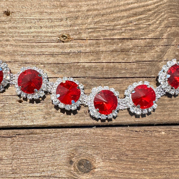 Rhinestone hat chain by BohoGroove, Ruby Slipper, showing large red round rhinestones surrounded by sparkling clear rhinestone details on a silver tone chain.