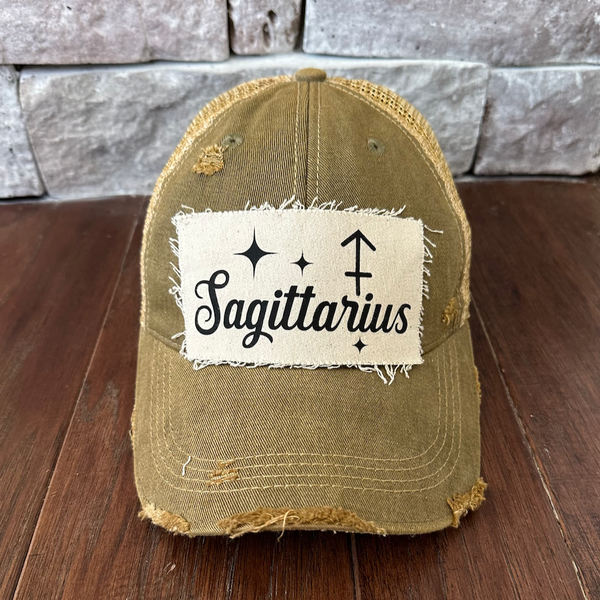 Sagittarius hat by BohoGroove with black Sagittarius lettering and constellation graphic on a distressed off-white custom patch on an olive vintage distressed snapback.