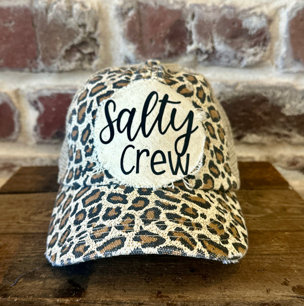Salty Crew hat by BohoGroove with black Salty Crew lettering on distressed off-white patch on a leopard vintage distressed snapback.
